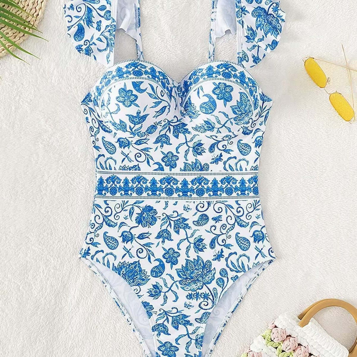 Blue and white floral one-piece bikini with chest pad and ruffled straps, perfect for swimwear and boudoir occasions.